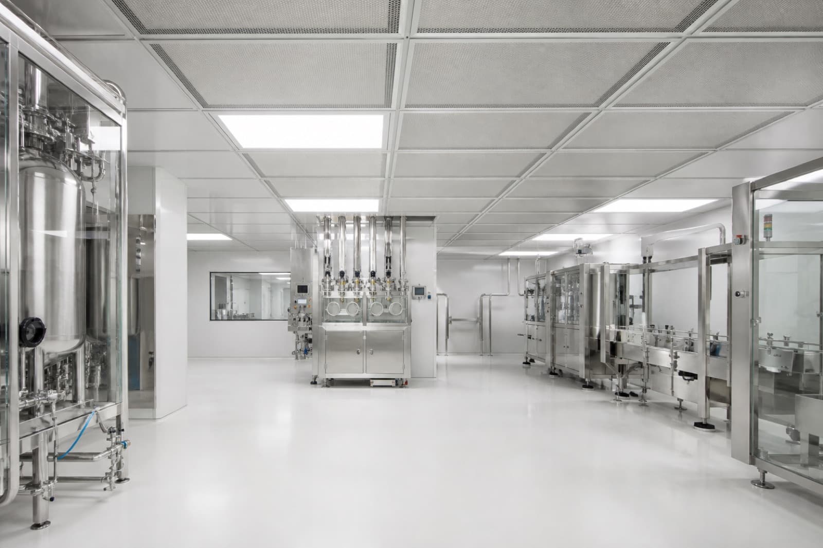 White pharmaceutical cleanroom with HEPA ceiling grid and stainless equipment